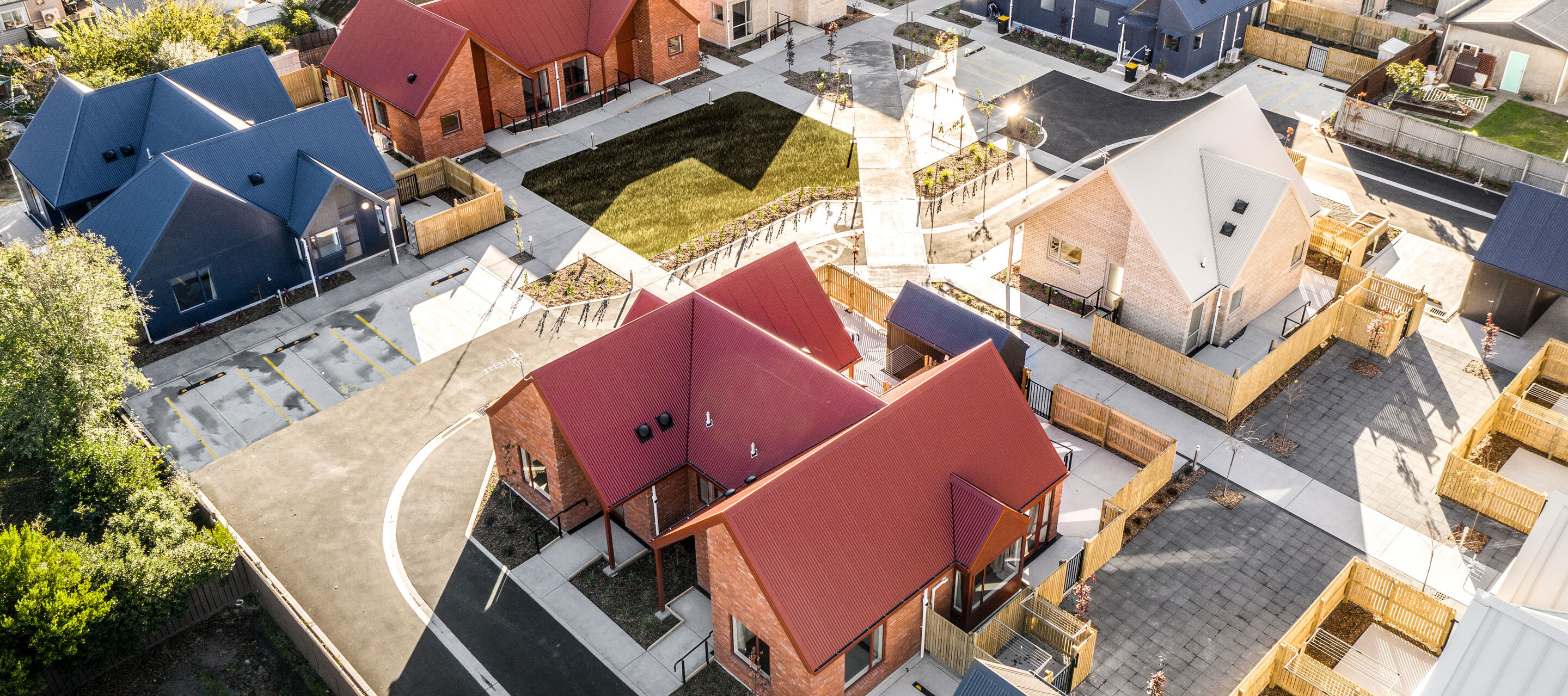 Home Capital Partners – aerial view of a completed affordable housing development in Rangiora, Canterbury (2019), showing multiple single-story homes with colourful roofs.
