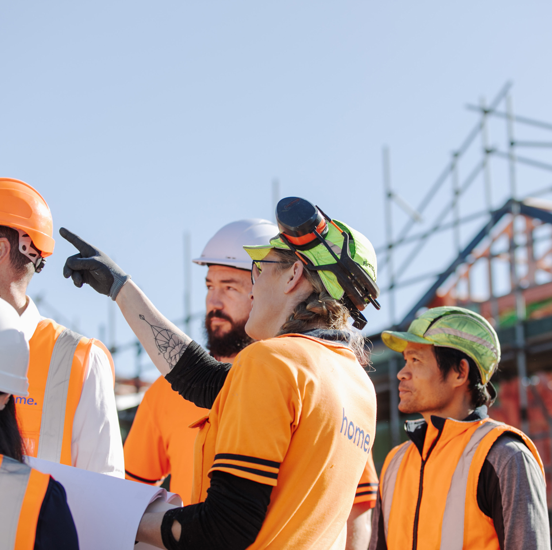 Home Capital Partners – a construction worker on-site building a house, illustrating the job creation aspect of housing investments.