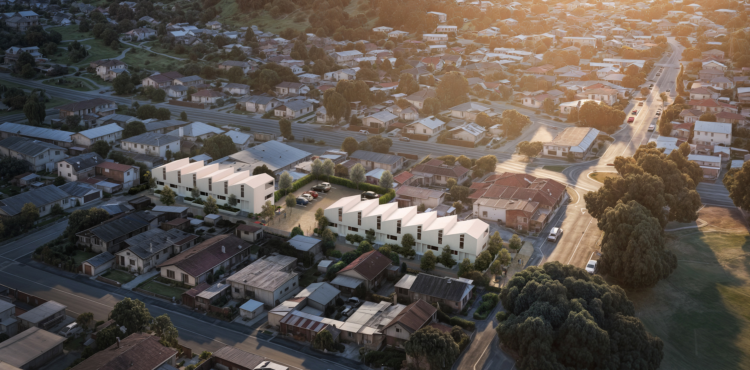 Home Capital Partners – aerial view of the Toi Toi (Nelson) project: two rows of modern white townhouses with central parking in a suburban block.